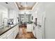 Galley kitchen featuring modern appliances and easy access to the dining area at 10842 W Evans Ave # 34, Lakewood, CO 80227