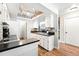 Well-lit kitchen with tiled backsplash, modern appliances, and convenient layout at 10842 W Evans Ave # 34, Lakewood, CO 80227