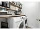 Efficient laundry area with shelving for storage and modern washer and dryer at 10842 W Evans Ave # 34, Lakewood, CO 80227