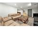 Finished basement living room with large sectional sofa and television at 10842 W Evans Ave # 34, Lakewood, CO 80227