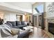 Bright living room featuring a fireplace, cozy seating, and sliding glass doors to a private outdoor space at 10842 W Evans Ave # 34, Lakewood, CO 80227