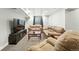 Basement living room featuring carpet, a tv, and several couches at 10842 W Evans Ave # 34, Lakewood, CO 80227