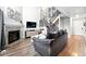 Comfortable living room with a fireplace, TV, sectional sofa, and an open staircase at 10842 W Evans Ave # 34, Lakewood, CO 80227