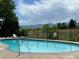 Beautiful community pool offers residents a refreshing escape with mountain views and lounge chairs at 10842 W Evans Ave # 34, Lakewood, CO 80227
