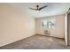 This cozy bedroom has plush carpet, a ceiling fan, a window with blinds, and a sliding closet door at 9655 E Center Ave # 11D, Denver, CO 80247