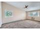 Bright bedroom with vaulted ceilings, carpeted floors, and shuttered windows at 9655 E Center Ave # 11D, Denver, CO 80247