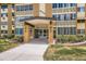 Inviting entrance with glass doors and prominent address signage, surrounded by landscaped greenery at 9655 E Center Ave # 11D, Denver, CO 80247