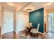 Cozy dining area featuring modern chairs and a glass table with an accent wall at 9655 E Center Ave # 11D, Denver, CO 80247