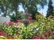 Beautiful garden fountain surrounded by colorful flowers and greenery at 9655 E Center Ave # 11D, Denver, CO 80247
