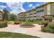 Attractive view of the complex showing a manicured garden, seating and the building's entrance at 9655 E Center Ave # 11D, Denver, CO 80247
