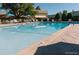 Inviting outdoor pool area with lounge chairs and umbrellas for relaxation at 9655 E Center Ave # 11D, Denver, CO 80247