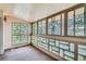 Bright sunroom with decorative block window and a wall of windows offering ample natural light and view at 9655 E Center Ave # 11D, Denver, CO 80247