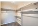 Spacious walk-in closet featuring carpeted floors and multiple shelving and hanging options at 9655 E Center Ave # 11D, Denver, CO 80247