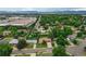 An aerial view showcases this home surrounded by mature trees and beautiful neighborhood at 1705 Lewis St, Lakewood, CO 80215