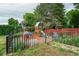 Backyard featuring a play set, grass, and a fenced garden area at 1705 Lewis St, Lakewood, CO 80215