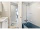 Bathroom with a blue bathtub and white tile walls at 1705 Lewis St, Lakewood, CO 80215