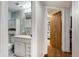Bathroom featuring a vanity with drawers and cabinet, toilet and wall mirror at 1705 Lewis St, Lakewood, CO 80215