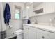Bright bathroom featuring a white vanity, neutral walls, a window, and a shower-tub combo at 1705 Lewis St, Lakewood, CO 80215