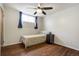 Bright bedroom with hardwood floors, a ceiling fan, and natural light from a window at 1705 Lewis St, Lakewood, CO 80215