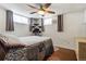 Bright bedroom featuring a ceiling fan and two large windows at 1705 Lewis St, Lakewood, CO 80215