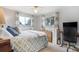 Serene bedroom featuring a comfortable bed, bright windows, and a ceiling fan at 1705 Lewis St, Lakewood, CO 80215