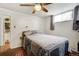 Cozy bedroom featuring a ceiling fan, a window with curtains, and hardwood floors at 1705 Lewis St, Lakewood, CO 80215