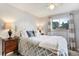 Comfortable bedroom featuring a window, night stand, and a patterned duvet at 1705 Lewis St, Lakewood, CO 80215