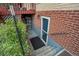 Basement level entrance with a screen door and a set of stairs at 1705 Lewis St, Lakewood, CO 80215