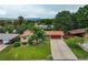 Well-maintained property boasts a long driveway, red two-car garage, and mature trees surrounding the home at 1705 Lewis St, Lakewood, CO 80215