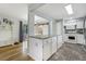 Open concept kitchen with a large island, stainless steel appliances, and hardwood floors at 1705 Lewis St, Lakewood, CO 80215