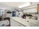 Well-lit kitchen featuring stainless steel appliances and ample countertop space at 1705 Lewis St, Lakewood, CO 80215