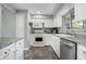 Bright kitchen with stainless steel appliances, white cabinets and marbled countertops at 1705 Lewis St, Lakewood, CO 80215