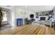 Bright living room with hardwood floors, fireplace and built-in bookshelves, adjacent to the front door at 1705 Lewis St, Lakewood, CO 80215