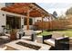 Inviting backyard features a cozy seating area around a fire pit and a covered pergola with outdoor dining space at 108 Arapahoe St, Golden, CO 80403