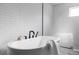 Bathroom featuring a soaking tub with modern fixtures, white subway tile, and glass shower at 108 Arapahoe St, Golden, CO 80403