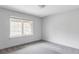 Bright bedroom featuring neutral carpet, trim, and large window at 108 Arapahoe St, Golden, CO 80403