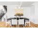 Dining room featuring a modern light fixture, hardwood floors, and open access to staircase at 108 Arapahoe St, Golden, CO 80403