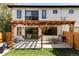 Beautifully designed backyard with a pergola-covered patio, dining area, and well-manicured lawn at 108 Arapahoe St, Golden, CO 80403
