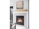 Contemporary fireplace featuring a brick surround, wooden mantel, and modern artwork at 108 Arapahoe St, Golden, CO 80403