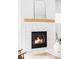 Close-up of a modern fireplace with a marble surround and wood mantel at 108 Arapahoe St, Golden, CO 80403