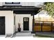 Modern farmhouse front door with black trim, white siding, and complementary landscaping at 108 Arapahoe St, Golden, CO 80403