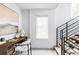 Bright home office features a modern desk, chair, stylish staircase and natural light from a large window at 108 Arapahoe St, Golden, CO 80403