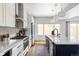 Bright kitchen featuring stainless steel appliances, long countertops, and a blue kitchen island at 108 Arapahoe St, Golden, CO 80403