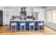 Bright kitchen features a central island with seating, stainless steel appliances, and stylish pendant lighting at 108 Arapahoe St, Golden, CO 80403