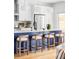 Bright kitchen features a central island with seating, stainless steel appliances, and stylish pendant lighting at 108 Arapahoe St, Golden, CO 80403