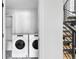 Modern laundry room featuring a stacked washer and dryer with a stylish tile floor at 108 Arapahoe St, Golden, CO 80403