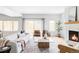 Bright living room featuring hardwood floors, modern furniture, and a cozy fireplace at 108 Arapahoe St, Golden, CO 80403