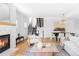 Open-concept living room with hardwood floors, fireplace, and modern staircase at 108 Arapahoe St, Golden, CO 80403