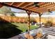 Relaxing patio area with pergola, ceiling fans, outdoor dining set, and lush landscaping for privacy at 108 Arapahoe St, Golden, CO 80403