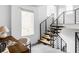 Modern staircase design with wood steps and black railing providing a clean, open transition between floors at 108 Arapahoe St, Golden, CO 80403